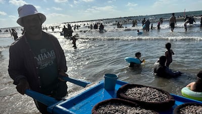 A man selling seafood on a beach in Egypt’s Mediterranean resort of Ras El Bar north of Cairo. Hamza Hendawi / The National