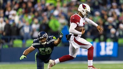 Arizona Cardinals quarterback Brett Hundley evades a tackle by Seattle Seahawks outside linebacker K.J. Wright (50) during the second half at CenturyLink Field. Arizona won 27-13. USA TODAY Sports