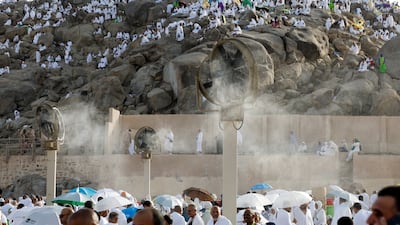 Pilgrims cool down under misting fans near Mount Arafat. Reuters