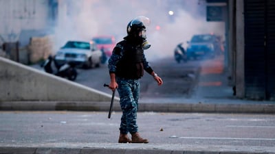 A member of the Lebanese riot police looks on after clashes with supporters of Lebanon's Shiite Hezbollah and Amal groups on December 14, 2019, in central Beirut. AFP
