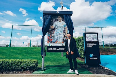 Sergio Aguero alongside a mural of his famous 93:20 moment at the club's Northern Quarter. Courtesy MCFC
