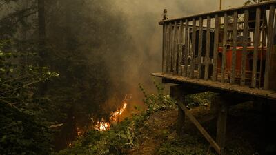 Fire approaches a home along Pine Flat Road after the CZU Lightning Complex fire tore through parts of Felton in Santa Cruz County, California. Bloomberg