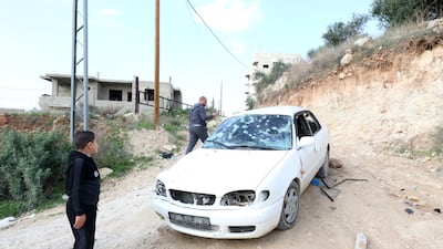 Palestinians inspect a bullet riddled car after an Israeli army raid at Nur Shams refugee camp, near the West Bank town of Tulkarem. EPA