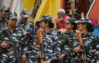 Police stand guard as a counter-terrorist task force raids PFI offices on Tuesday. EPA