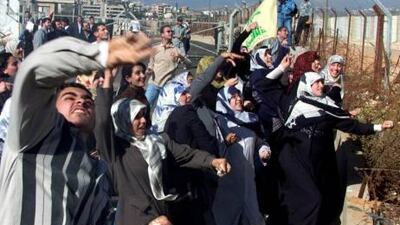 Lebanese students throw stones at Israeli soldiers at Fatima's Gate in Kfar Kila at the Lebanon-Israel border 10 November 2000 during a demonstration to support the Palestinian intifada, or uprising, against Israeli troops in the Palestinian territories that has taken 199 lives, most of them Palestinian, since a wave of violence exploded in late September. AFP PHOTO/Ramzi HAIDAR