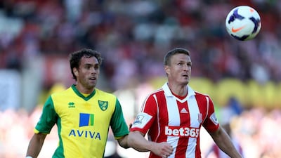 Norwich City’s Johan Elmander, left, and Stoke City’s Robert Huth run for the ball. Lynne Cameron / PA