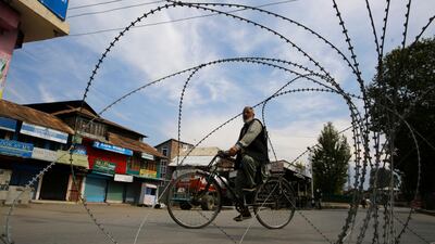 A man rides his bicycle during shutdown in Srinagar, Kashmir. Farooq Khan / EPA