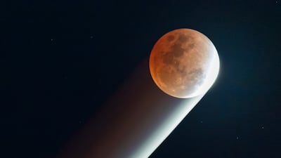 A Blood Moon, caused when it passes through the Earth’s shadow, hangs over Laguna province in the Philippines. Getty Images
