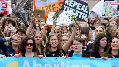 Protesters hold up placards as they take part in a march calling for the legalising of abortion in Ireland. AFP PHOTO / Paul FAITH