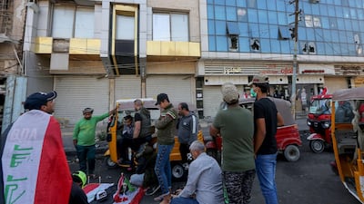 Iraqi anti-government protesters light candles at the site of a bomb explosion near Baghdad's Tahrir Square on November 16, 2019. AFP