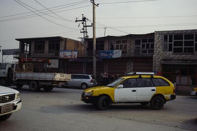 Cars and Taxis drive past damaged shops and homes in the Qabil Bai district of Kabul. Ivan Flores, The National