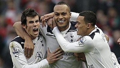 Younes Kaboul, centre, celebrates the match-winning goal with his Tottenham teammates Gareth Bale, left, and Jermaine Jenas.