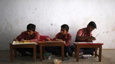 Muslim boys attend a painting class at a school.
