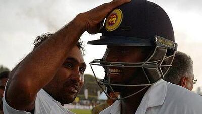Sri Lankan cricket team captain Angelo Mathews, right, and teammate Mahela Jayawardene celebrate after winning the opening Test match between Sri Lanka and Pakistan at the Galle International Cricket Stadium in Galle on August 10, 2014. AFP PHOTO/ Ishara S. KODIKARA
