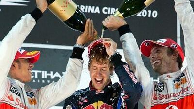Lewis Hamilton, left, and Jenson Button, the 2008 and 2009 champions, congratulate Sebastian Vettel, the 23-year-old German who takes over from Hamilton as the youngest F1 champion.