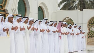 Sheikh Mohammed bin Zayed, seventh left, prays at the grave of his father, the late Sheikh Zayed bin Sultan, during Eid Al Adha prayers at the Sheikh Zayed Grand Mosque. Seen with, left to right, Sheikh Nahyan bin Mubarak, Sheikh Khaled bin Zayed, Chairman of the Board of Zayed Higher Organisation for Humanitarian Care and Special Needs, Sheikh Abdullah bin Zayed, UAE Minister of Foreign Affairs and International Cooperation, Sheikh Mansour bin Zayed, UAE Deputy Prime Minister and Minister of Presidential Affairs, Sheikh Hazza bin Zayed, Vice Chairman of the Abu Dhabi Executive Council, Dr Farouq Hammada, the Islamic Consultant for the Crown Prince Court of Abu Dhabi, Sheikh Mohammed bin Zayed, Sheikh Nahyan Bin Zayed, Lt Gen Sheikh Saif bin Zayed, Sheikh Tahnoon bin Zayed, Sheikh Hamed bin Zayed, Chairman of the Crown Prince Court of Abu Dhabi and Abu Dhabi Executive Council Member, Sheikh Omar bin Zayed, Deputy Chairman of the Board of Trustees of Zayed bin Sultan Al Nahyan Charitable and Humanitarian Foundation, Sheikh Abdullah bin Mohammed, Chairman of Al Ain FC, Sheikh Zayed bin Mohammed, and Major Gene Sheikh Khaled bin Mohammed, Deputy National Security Adviser. Ryan Carter / Crown Prince Court — Abu Dhabi