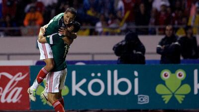 Mexico's Oribe Peralta, right, celebrates with teammate Mexico's Javier Hernandez after scoring during a 2014 World Cup qualifying soccer match in San Jose, Costa Rica, Tuesday, Oct. 15, 2013. (AP Photo/Moises Castillo)