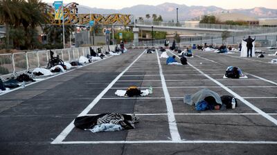 Homeless people sleep in a temporary parking lot shelter at Cashman Center, with spaces marked for social distancing to help slow the spread of coronavirus disease (COVID-19) in Las Vegas, Nevada, U.S. REUTERS