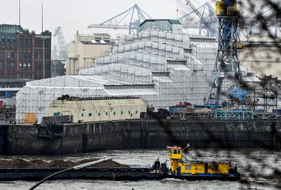The Dilbar yacht pictured in a harbour in Hamburg on Thursday covered in scaffolding and tarpaulin after authorities seized it. Photo: REUTERS / Fabian Bimmer