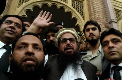 Hafiz Saeed, centre, the founder of militant group Lashkar-e-Taiba and the head of banned charity Jamat-ud-Dawa, waves to supporters after being released from house arrest in 2017. EPA