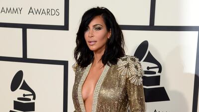 2015: Kim Kardashian wears a gold glittering gown by Jean Paul Gaultier for the 57th annual Grammy Awards. EPA