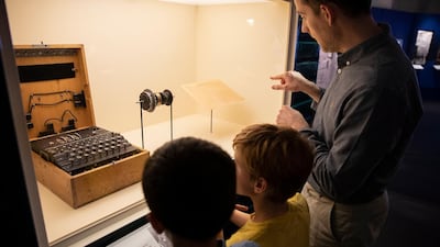 Visitors examine an enigma machine. Courtesy Science Museum Group