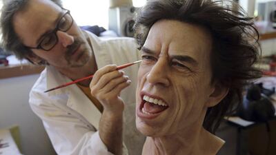 Painter Franck Bruneau works on the head of Rolling Stones lead singer Mick Jagger at their workshop in Paris on April 9, 2014. Philippe Wojazer / Reuters