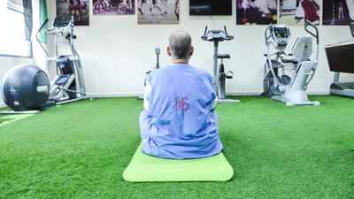 An inmate begins a yoga session at Dubai Central Correctional Facility. Reem Mohammed / The National