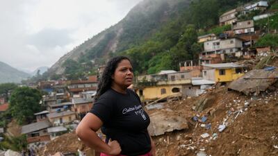 Priscilla Neves waits for news about her missing parents, who were in their family home when it was covered by mudslides. AP