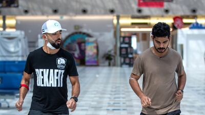 Famish is given some pointers on heel and toe running techniques by coach Mohammed Ibrahim from Desert Shield Fitness Gym.