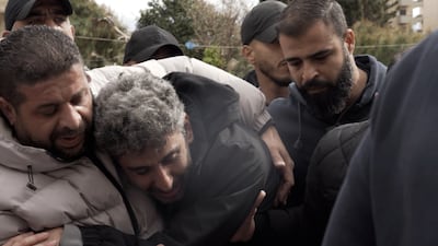 Ibrahim Sidawi, second from left, said he wanted only 'the poor, people like me, who know how I feel', to attend his son's funeral. The National