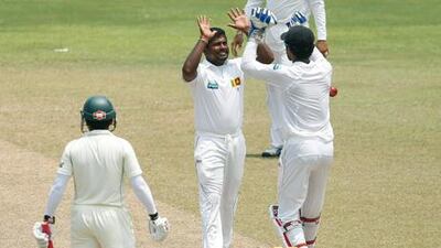Sri Lanka's Rangana Herath celebrates after taking Mushfiqur Rahim's wicket.