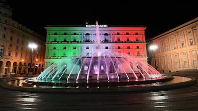 The palace of Liguria region in the De Ferrari square is illuminated with the tricolor lights of the Italian flag, in a national tribute amid the coronavirus epidemic in Genoa, Italy, 21 March 2020. EPA