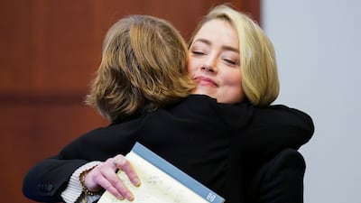 Heard embraces her lawyer Elaine Bredehoft. AP