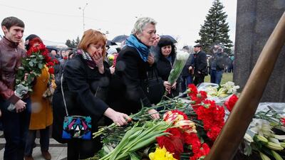Relatives and fellow mourners lay flowers at a Russian memorial to the 62 people killed when a flydubai Boeing 737-800 crashed in bad weather at Rostov-on-Don airport after an abortive landing attempt last year. Valery Matytsin / Tass / Getty Images