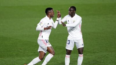 Vinicius Junior of Real Madrid celebrates with Ferland Mendy after scoring their team's first goal during the La Liga Santander match between Real Madrid and Real Sociedad. Getty Images