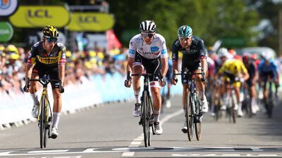 Slovenian rider Tadej Pogacar, centre, of the UAE-Team Emirates and Primoz Roglic, left, of the Jumbo Visma team cross the finish line during the second stage of the Tour de France. EPA