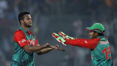 Bangladesh’s Shakib Al Hasan, left, celebrates with wicketkeeper Mushfiqur Rahim during their ODI win Saturday over Zimbabwe in Dhaka. AM Ahad / AP / November 7, 2015