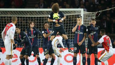 Paris St Germain’s David Luiz jumps to head the ball during a free kick against Monaco. Charles Platiau / Reuters