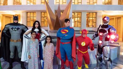 Sheikha Salama bint Mohammed (L) and Sheikha Fatima bint Mohammed (2nd L) stand for a photograph with super heroes during the opening of Warner Bros World Abu Dhabi. Hamad Al Kaabi / Crown Prince Court - Abu Dhabi