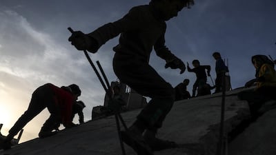 Children play on a destroyed house next to destroyed mosque in al-Nashabieh City, Syria. Mohammed Badra / EPA