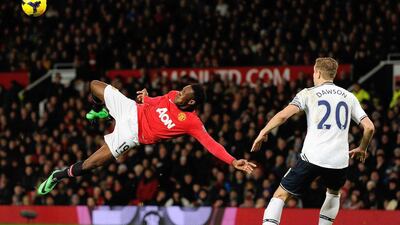Manchester United striker Danny Welbeck, left, attempts an overhead kick during an English Premier League football match against Tottenham Hotspur on Wednesday. Andrew Yates / AFP