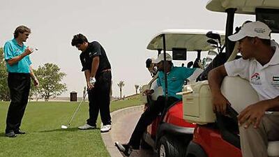 Khalid Yousuf, 19, is considered the UAE's best golfer. He and his teammates Ahmed, right, and Abdullah al Musharrekh, far right, play at Abu Dhabi Golf Club.