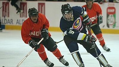Jamil David bin Ahmad Mokhar of Malaysia skates with the puck during his side's 10-1 win over India.