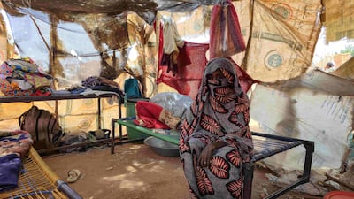 A Sudanese woman sits inside a shelter for displaced people in the Kordofan region. AFP