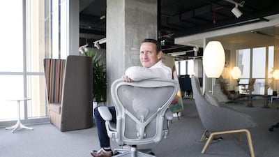 Chris Morley, the head of design for Middle East and Africa at Herman Miller, with an Aeron office chair. Reem Mohammed / The National
