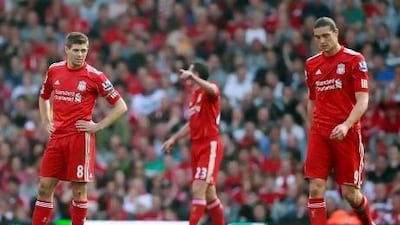 Steven Gerrard, left, the Liverpool captain and Andy Carroll, right, who at £35 million represents Kenny Dalglish's most expensive signing in his second stint as manager. Liverpool lost 2-1 at home to lowly Wigan Athletic at Anfield on Saturday, prompting the manager to cite tiredness as a reason. Tim Hales / AP Photo