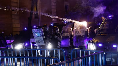 Police use shields to protect themselves from bottle-rockets launched by demonstrators. AFP