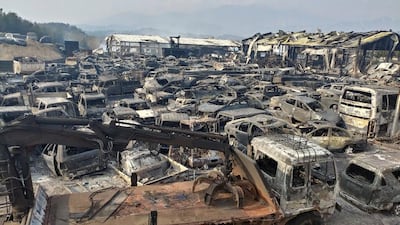Burnt vehicles fill a junkyard after being hit by a massive forest fire that started the previous day. Yonhap / EPA