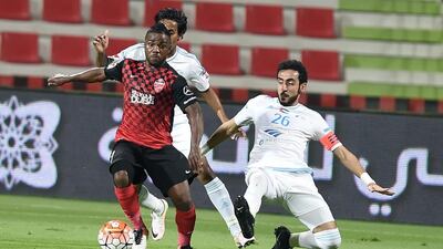 Al Ahli's Ismail Al Hammadi, left, evades two Baniyas players during their Arabian Gulf League clash on Friday evening. Courtesy Arabian Gulf League